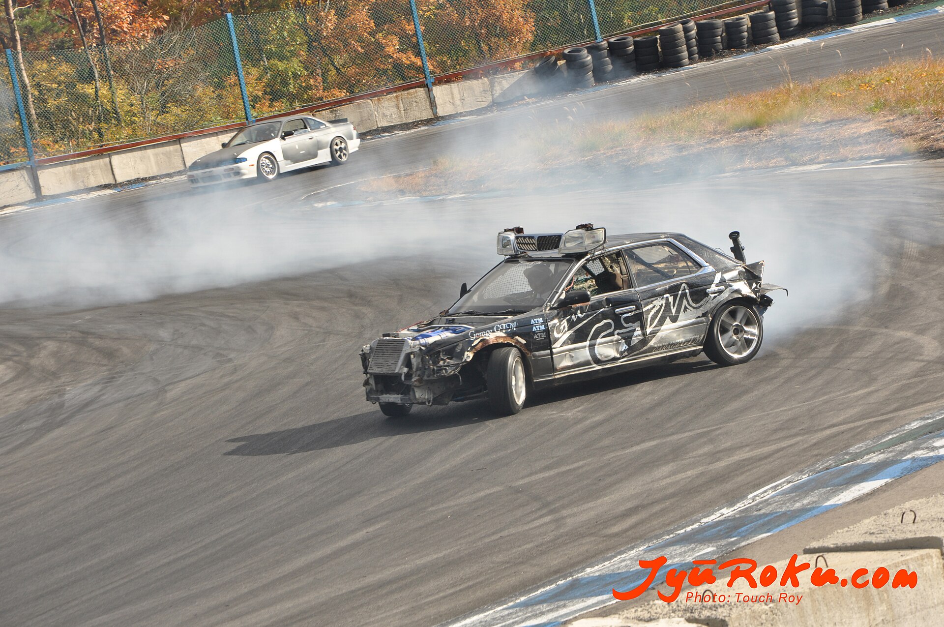 Drifting cars producing tire smoke on the Ebisu Circuit track in Fukushima