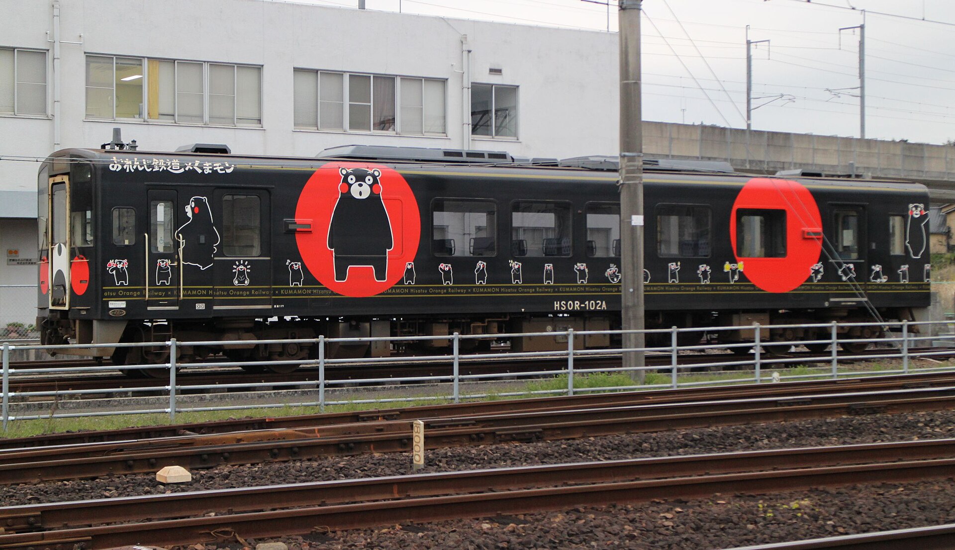 Hisatsu Orange Railway train decorated with Kumamon artwork on the tracks in Kyushu